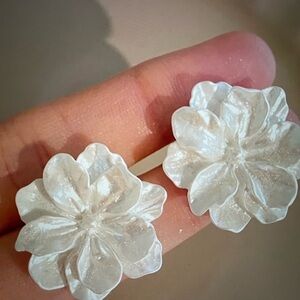 Pierced earrings fashion jewelry. Pearlescent white flower.